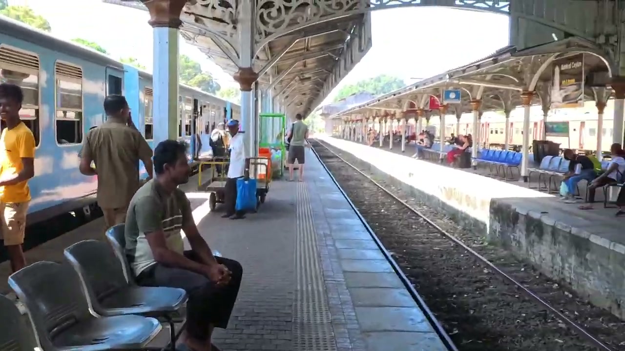 Kandy railway station platform with blue train, Sri Lanka