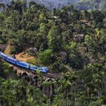 Blue train crossing the Nine Arches Bridge in Ella, Sri Lanka