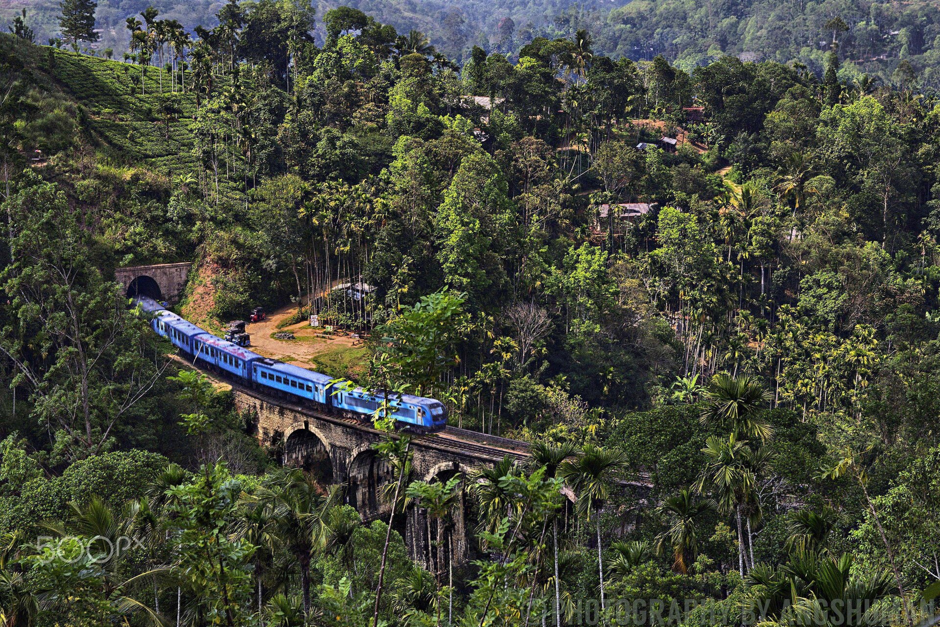 Blue train crossing the Nine Arches Bridge in Ella, Sri Lanka