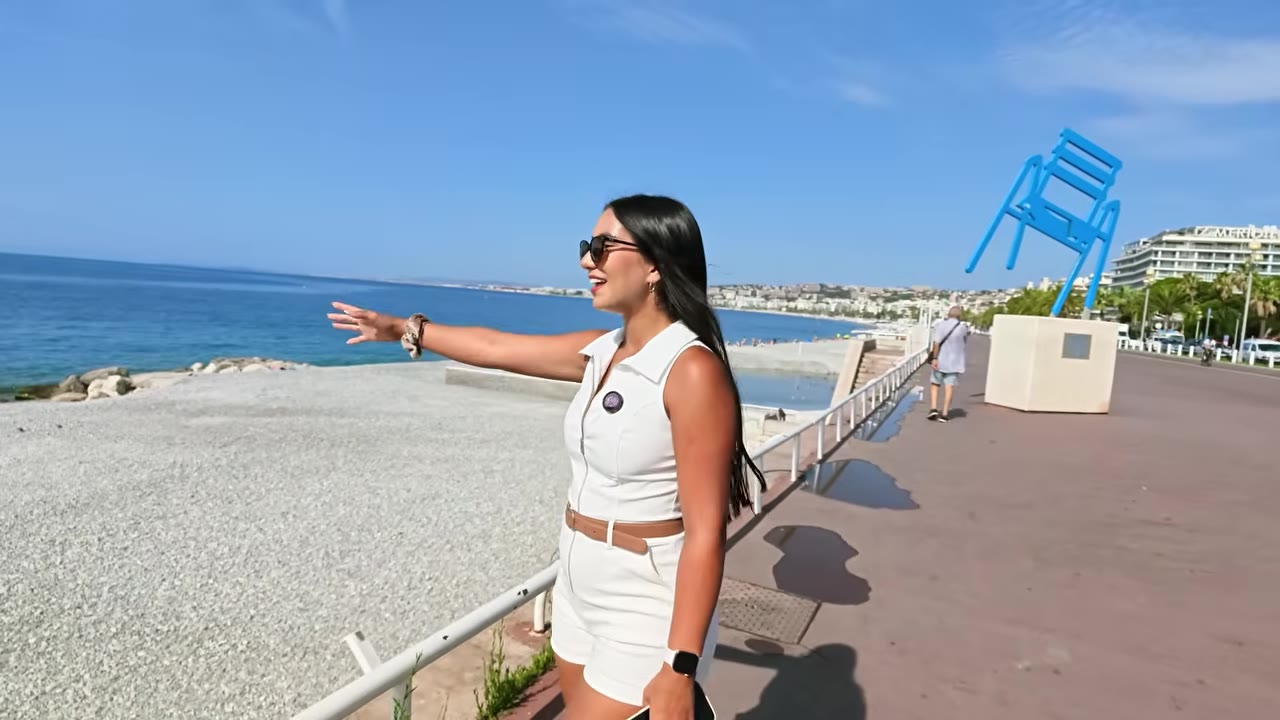 Pebble beach and turquoise Mediterranean water beside the Promenade des Anglais in Nice
