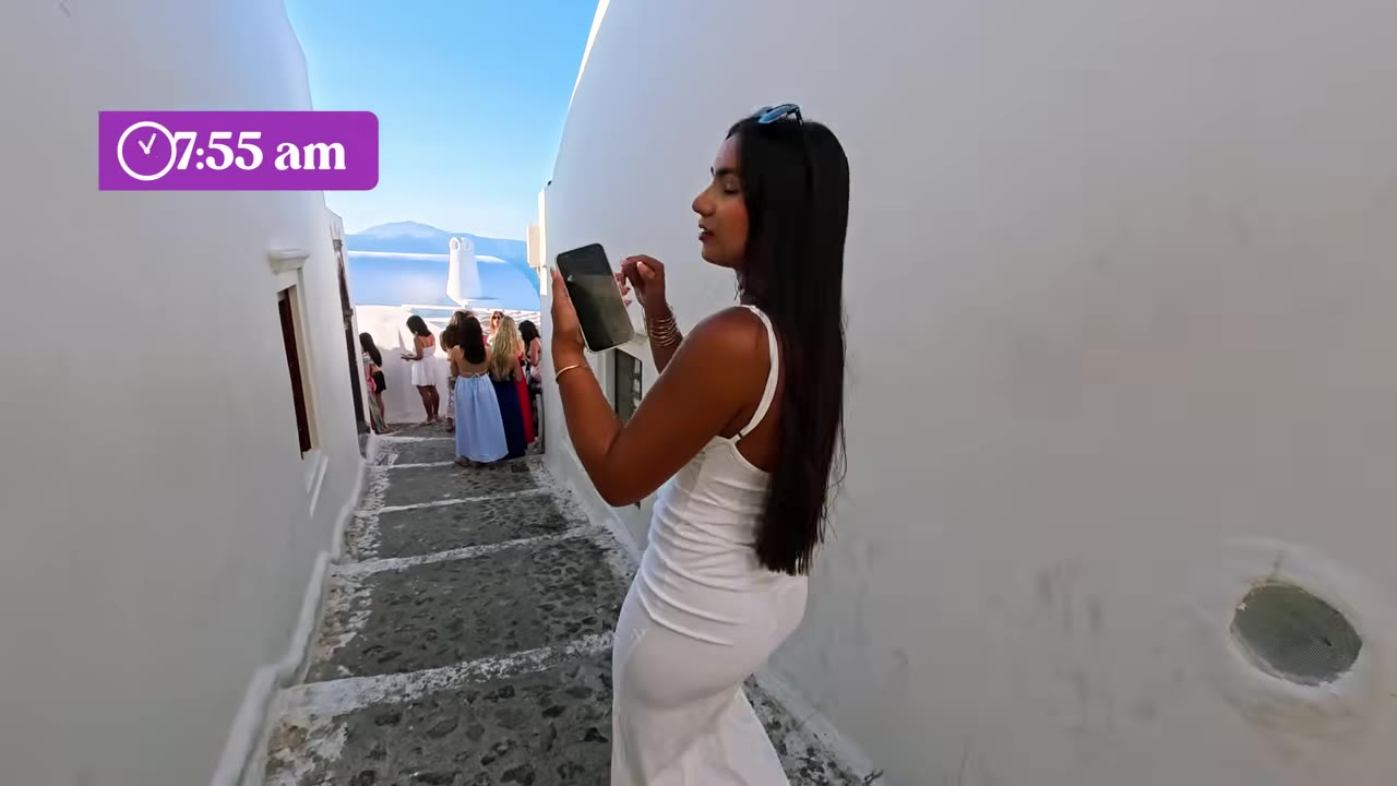 Whitewashed Santorini buildings and blue-domed churches above the caldera