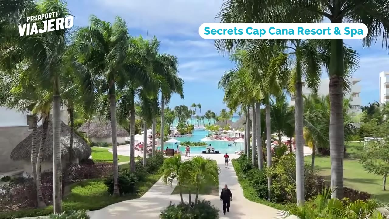 Guests relaxing beside a resort pool near the beach in Punta Cana