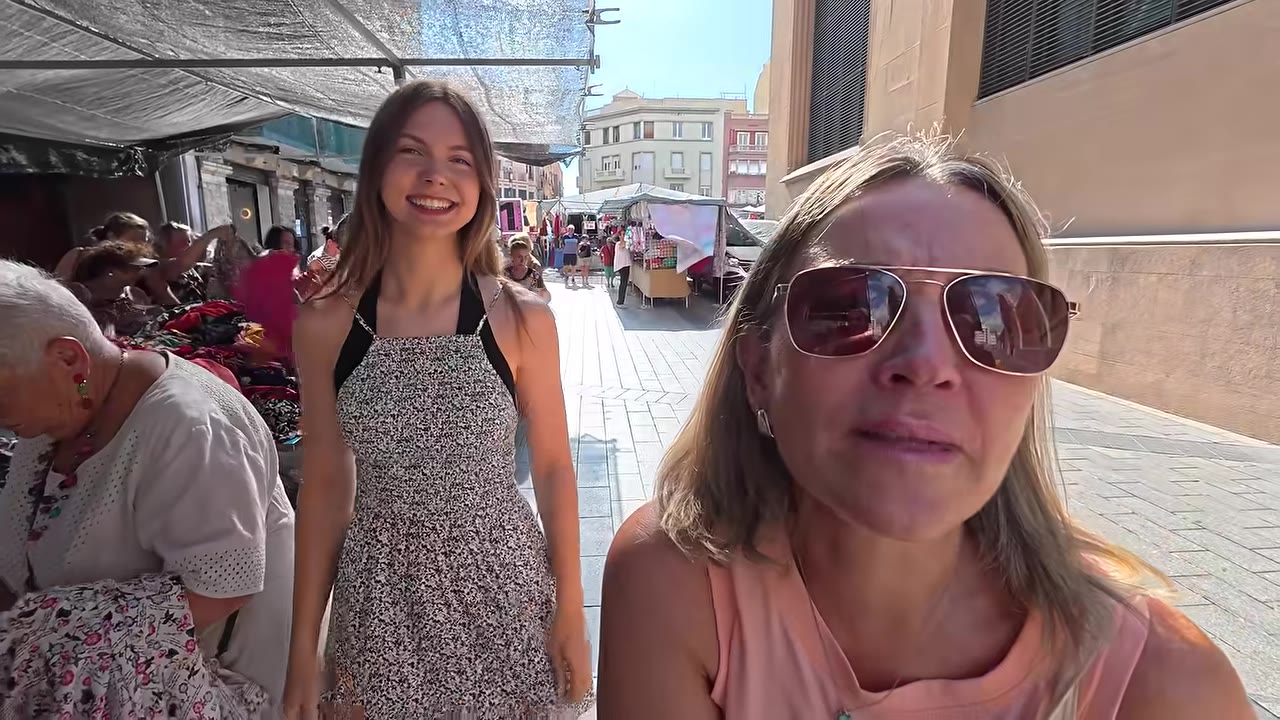 Travelers walking through a lively Spanish street market